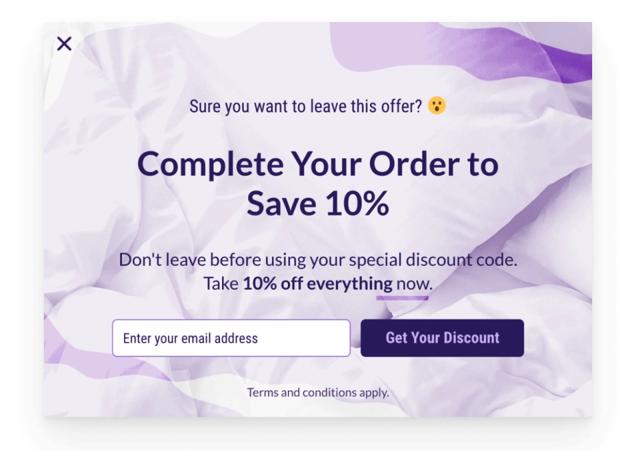 Exit-intent popup format offering 10 % off with an email field and purple bedding background.